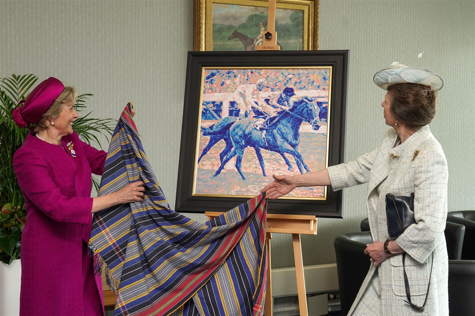 The Princess Royal receiving a gift to the Queen from Epsom Downs Racecourse presented by Julia Budd (Megan Ridgwell on behalf of The Jockey Club/PA)
