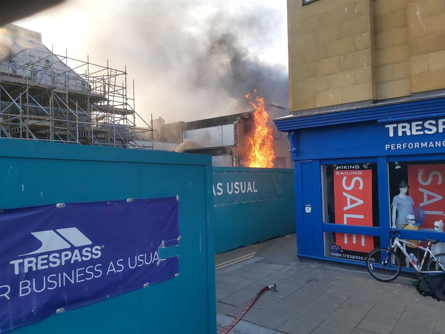 Flames pouring out of Poundland shortly after the fire began.