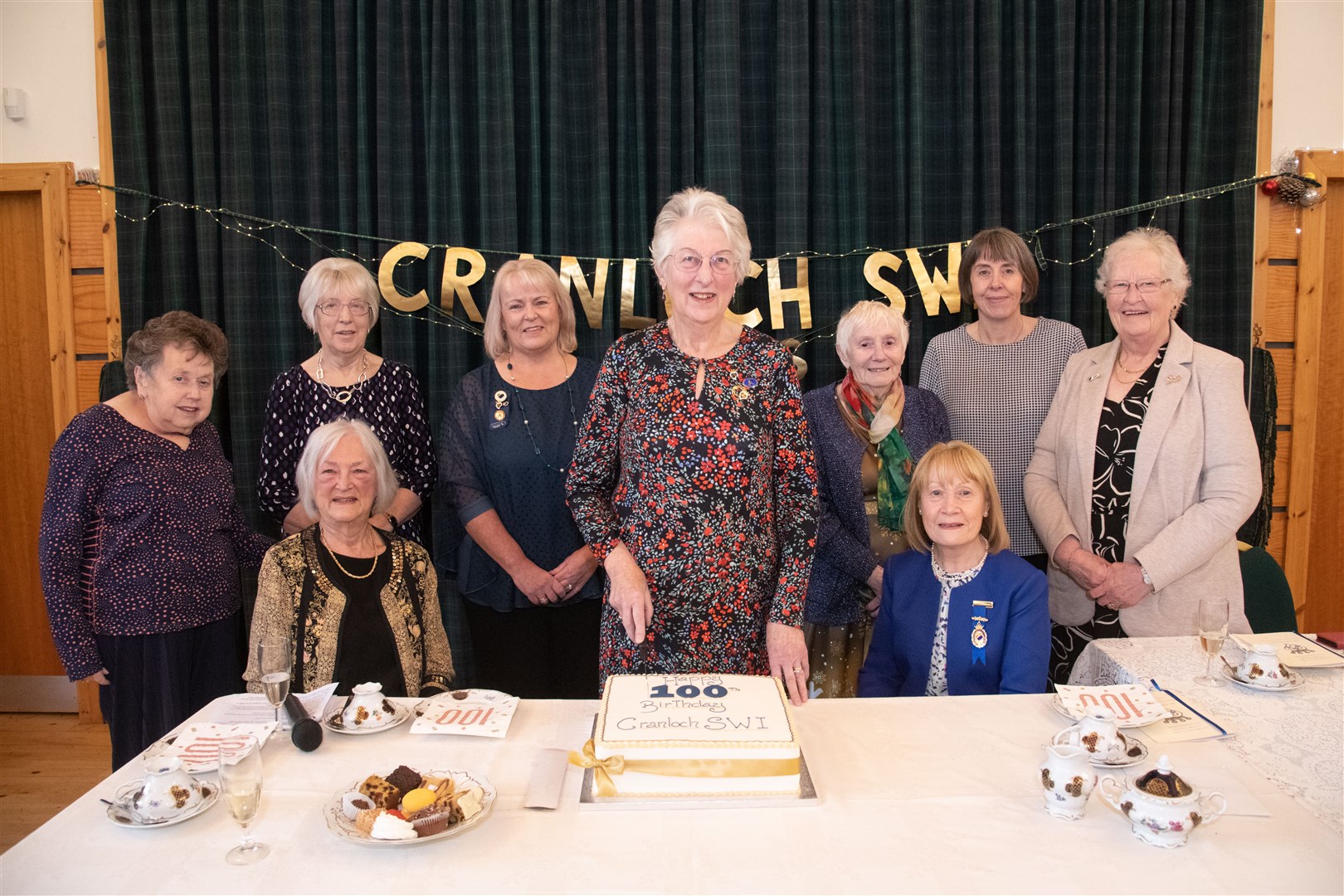 Meg Anderson (centre), the longest serving member of the Cranloch SWI, cuts the cake to celebrate their 100th anniversary. Picture: Daniel Forsyth