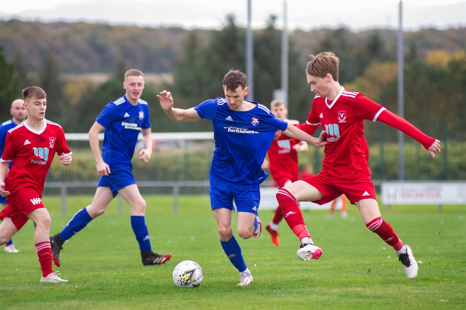 Lossiemouth's Ryan Farquhar, who would see red later in the game, tries to weave his way through the Vale midfield. ..Deveronvale FC (6) vs Lossiemouth FC (0) - Highland Football League - Princess Royal Park, Banff 23/10/2021...Picture: Daniel Forsyth..