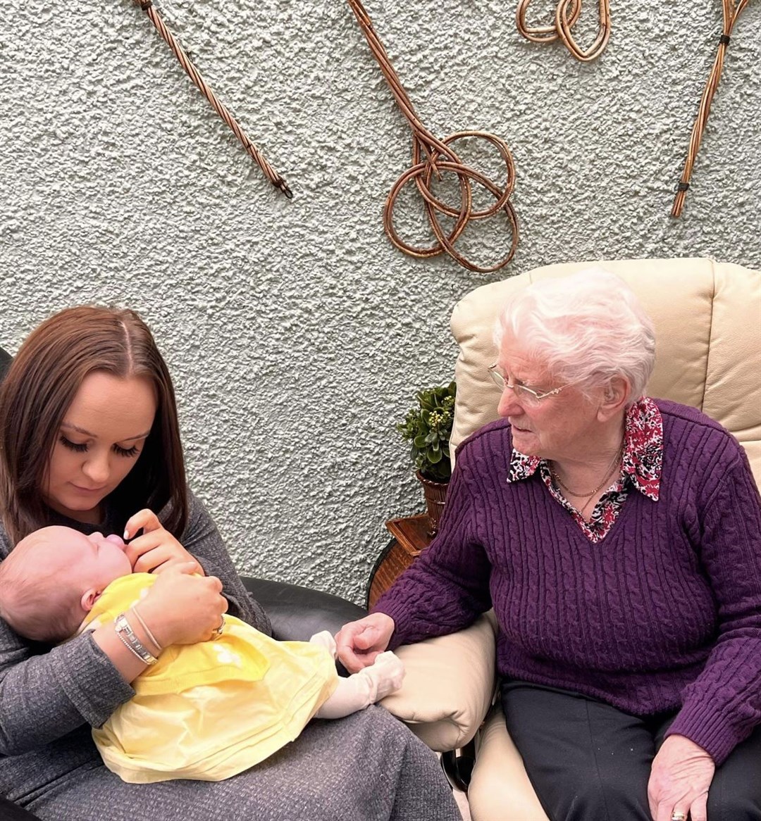 Mother Caera MacDonald holds 11-week old baby Ruby Irene MacKenzie, with Ruby's great great grandmother Irene McInnes looking on.