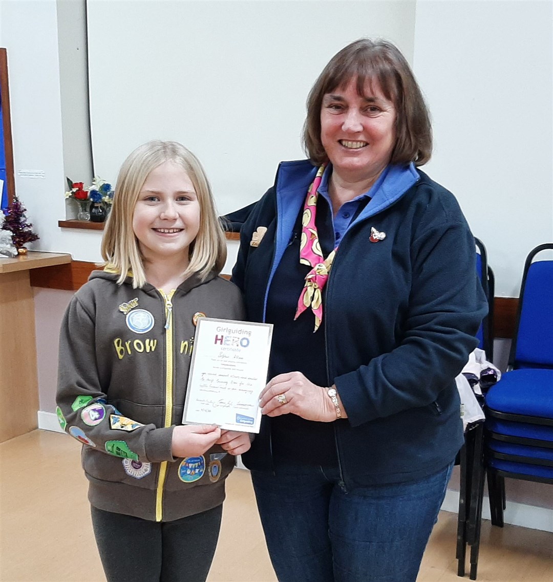 Sophie Allan is presented with her award by Louise Winder, Girlguiding Moray's county commissioner.
