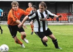 Ashley Grant of Rothes (left) battles for possession against Wick