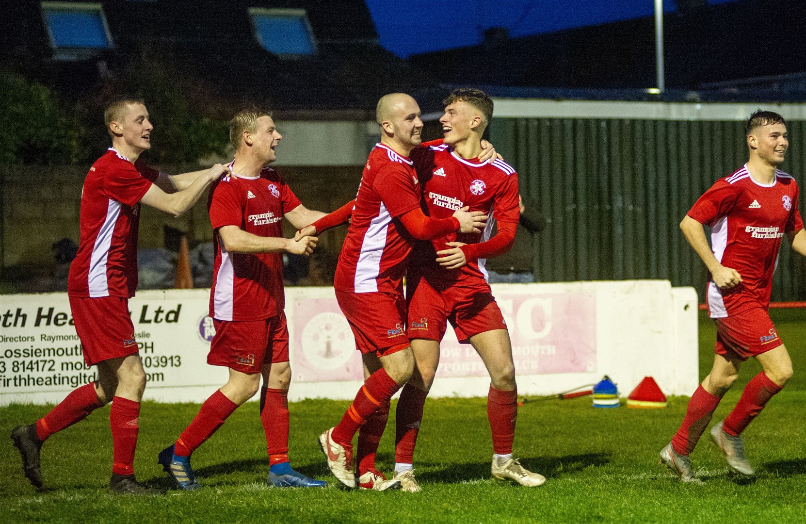 Celebration time for the Lossiemouth team. Picture: Daniel Forsyth..