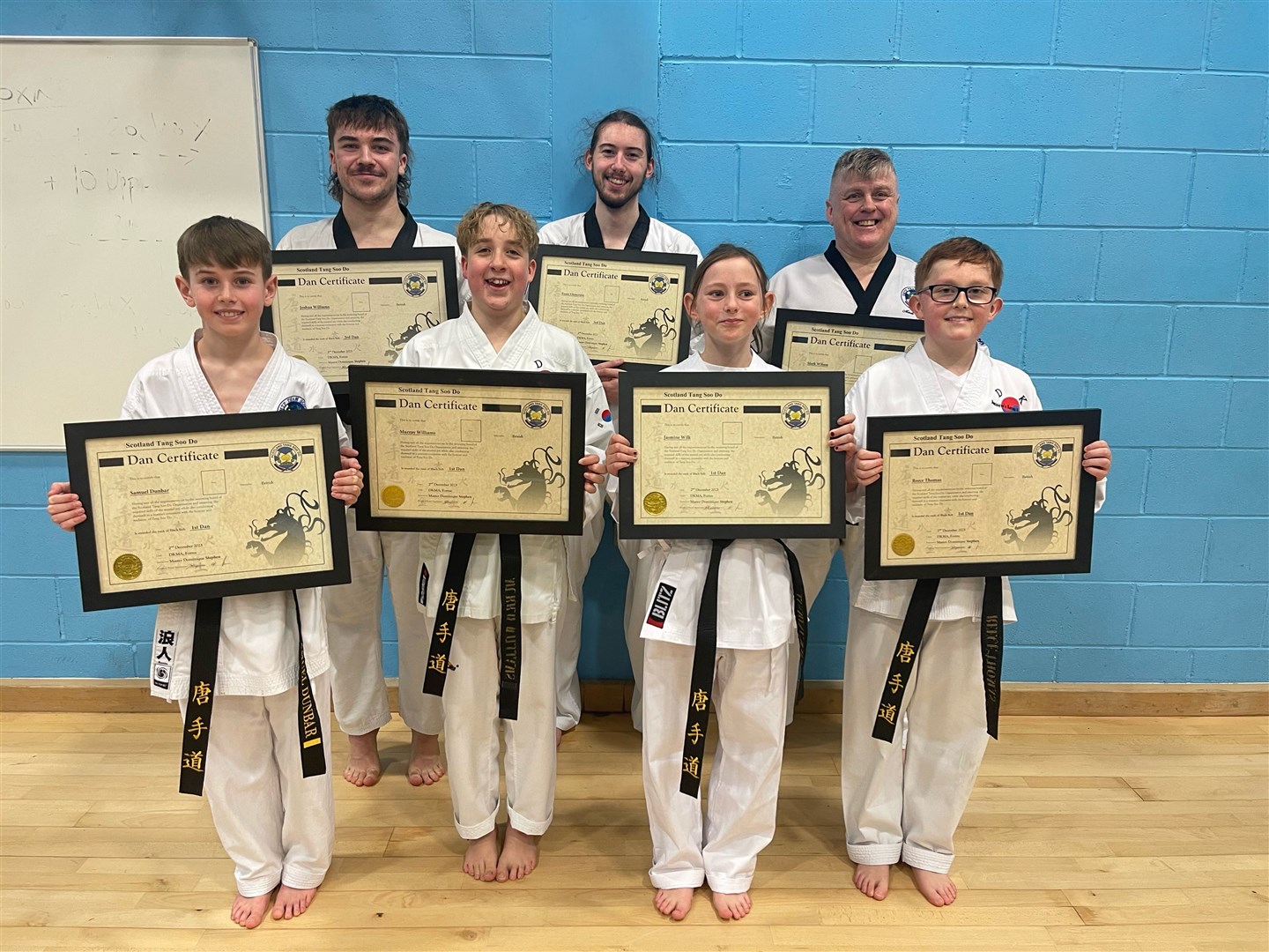 The DKMA students show off their new grades after a successful black belt testing in Inverness.