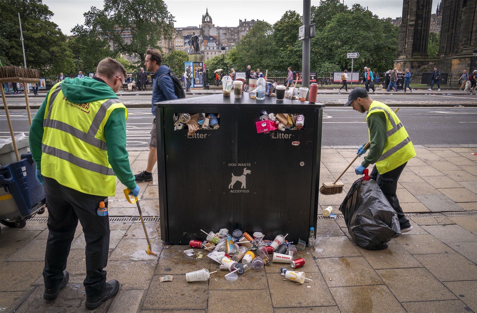 Staff from Essential Edinburgh collect some of the litter from around the bins along Princes Street in Edinburgh (Jane Barlow/PA)