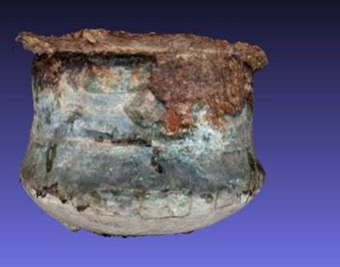 This iron cooking cauldron was found buried with a bronze cauldron inside it.