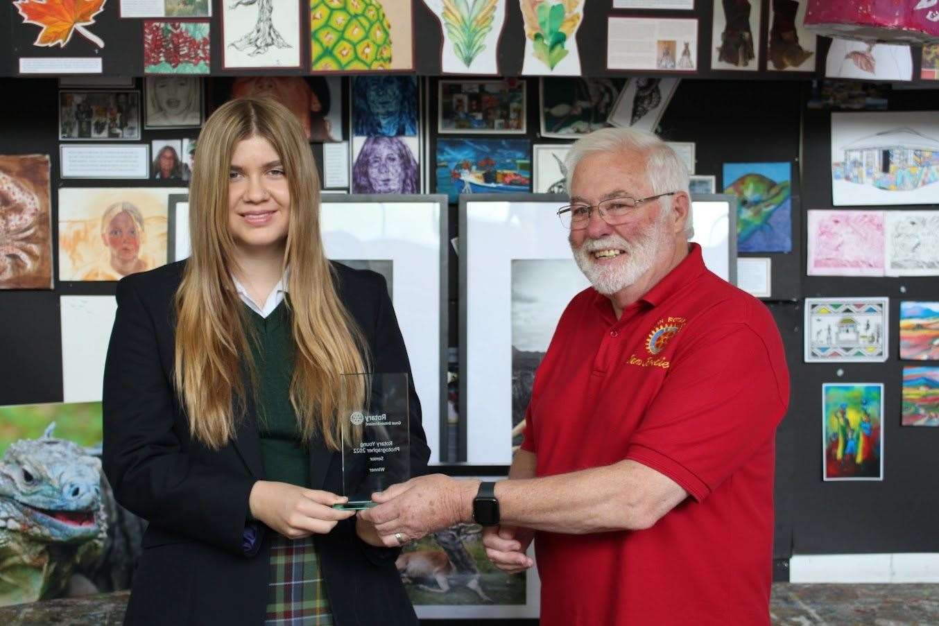 Ian Brodie presents Olivia Barnett with her trophy for winning the national competition.