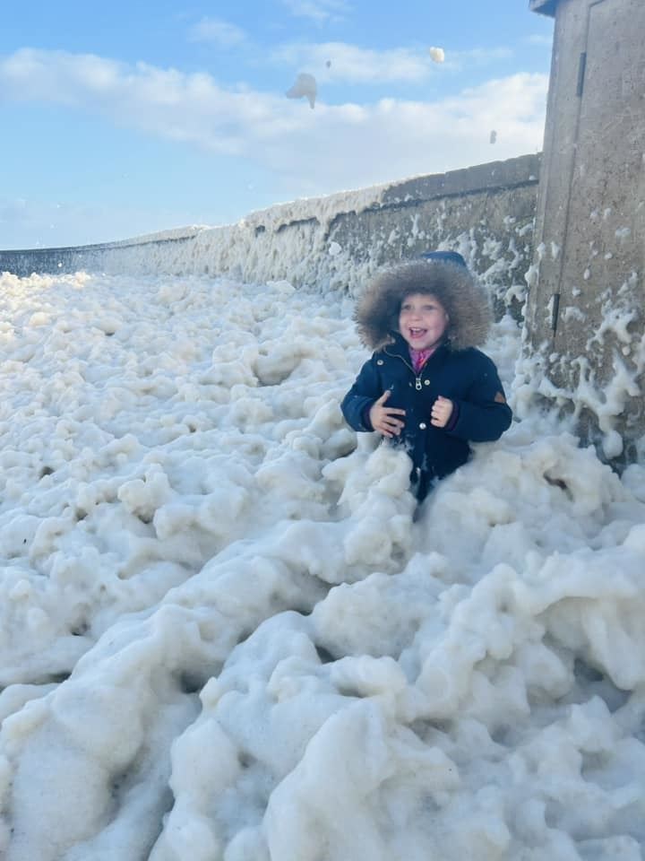 Playing in the sea foam at Lossie. Picture: Kayleigh Dewar.