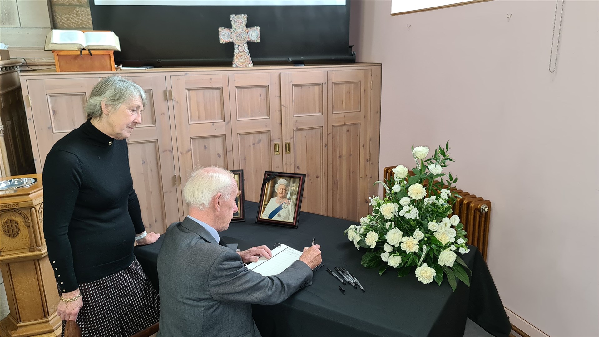 Deputy Lieutenants for Banffshire Hughie Monro and Patricia Lawson sign the book of condolence in Aberlour.
