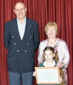 On winning the Jean Maciver Memorial Award, Lili Anderson stands with Moray Council representative Alistair Farquhar and speech convener Sandra Maclennan.