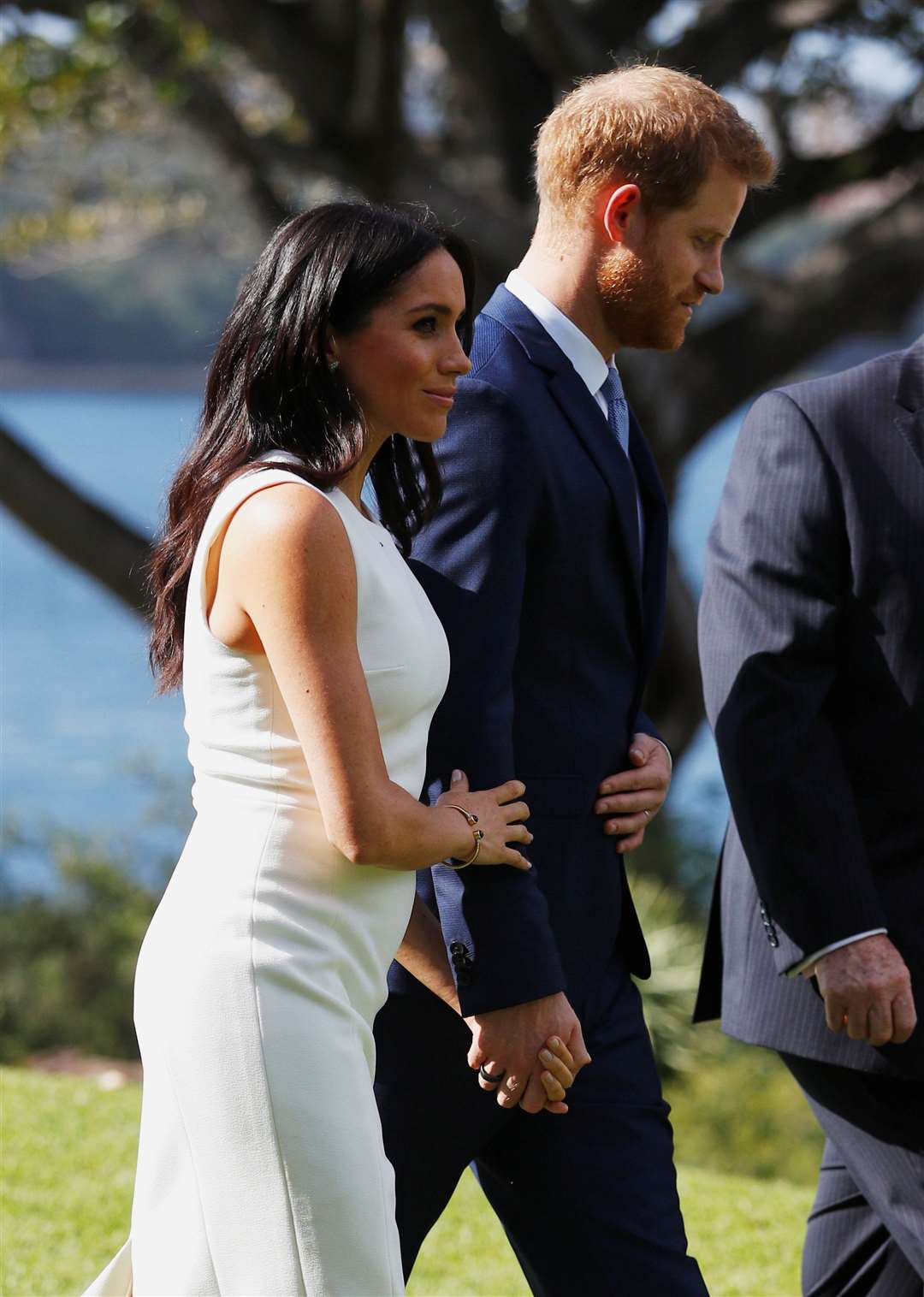 Meghan, with a tiny bump, on the first day of a tour to Australia (Phil Noble/PA)