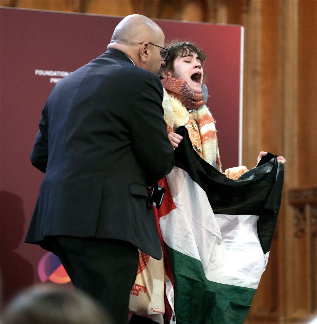 A pro-Palestinian protester is removed after interrupting shadow foreign secretary David Lammy during his speech to the Fabian Society conference in central London (Maja Smiejkowska/PA)