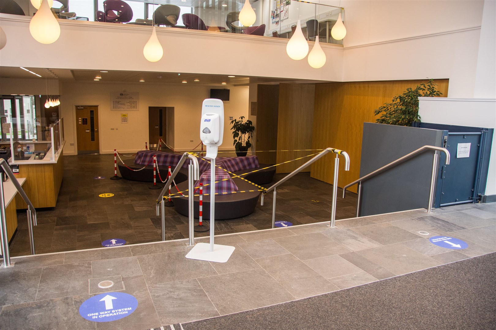 The 'new normal' as hand sanitizer, floor markings and one-way systems greet people as they arrive at reception in Moray College UHI. Picture: Becky Saunderson.