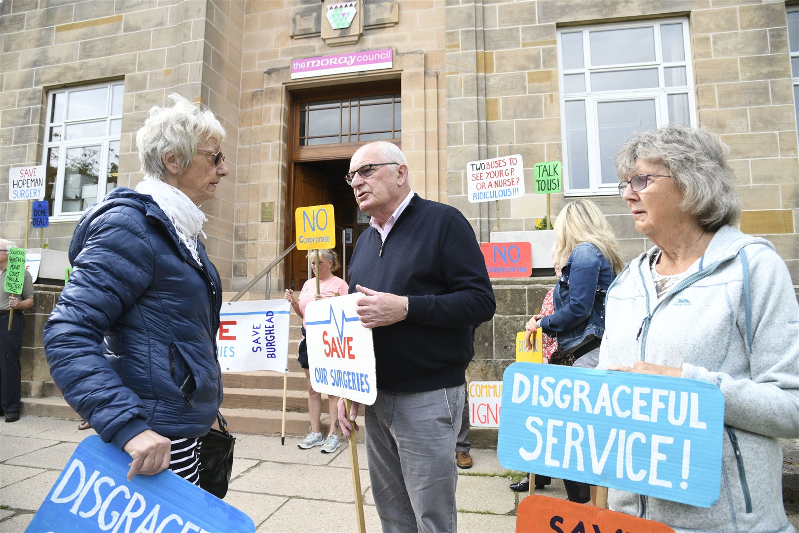 Liz Mcknockiter (l) with Dennis Slater (middle) outside Moray Council's headquarters. Picture: Daniel Forsyth