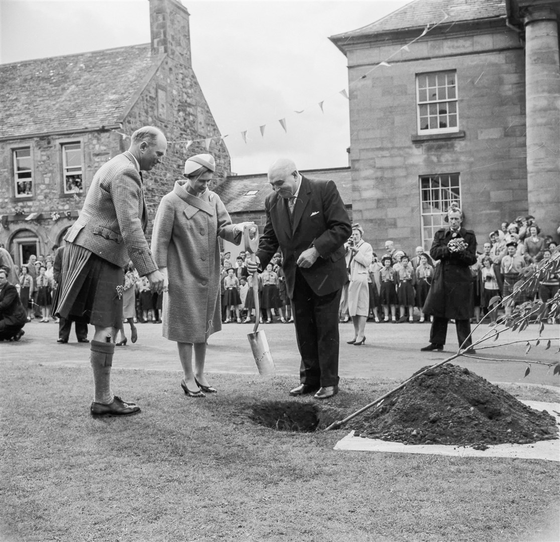 The Queen plants a tree in Fochabers in 1961. People can lay floral tributes to Her Majesty at designed gardens in Moray and these will ultimately be composted for a future tree planting in her memory. Picture: The Northern Scot archives