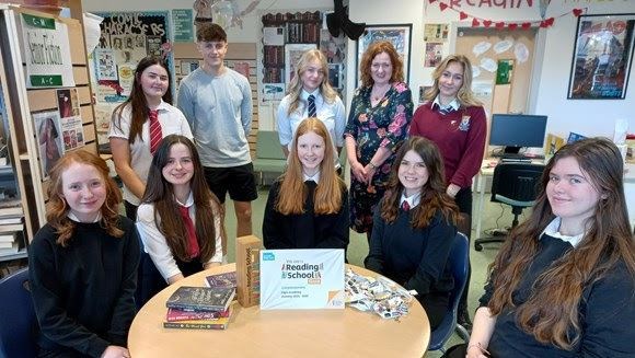 Elgin Academy pupils with librarian Shelagh Toonen and the gold award .
