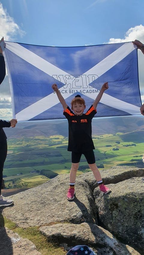 Evelyn Mitchell made it to the top of Ben Rinnes to support Weir Black Belt Academy.