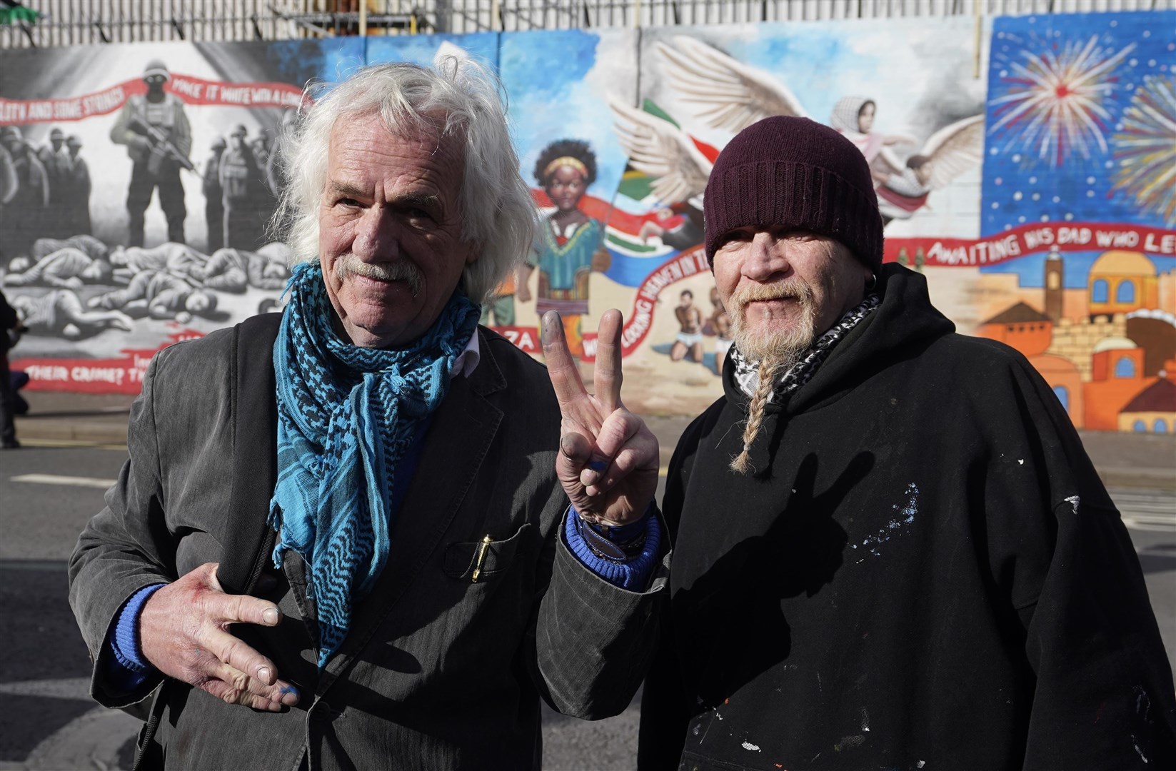 Mural artist Danny Devenny (left) and Marty Lyons at the unveiling of the International Wall in Belfast after it was transformed into a Gaza mural (Niall Carson/PA)