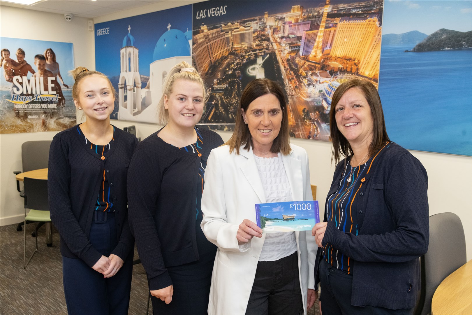 Hay's Travel assistant manager Karen Pitt (right) presents Louise Marandola with a voucher for £1000. They are joined by Hay's Travel apprentice travel consultant Iona Alexander (left) and travel consultant Vykky Johnston. Picture: Beth Taylor