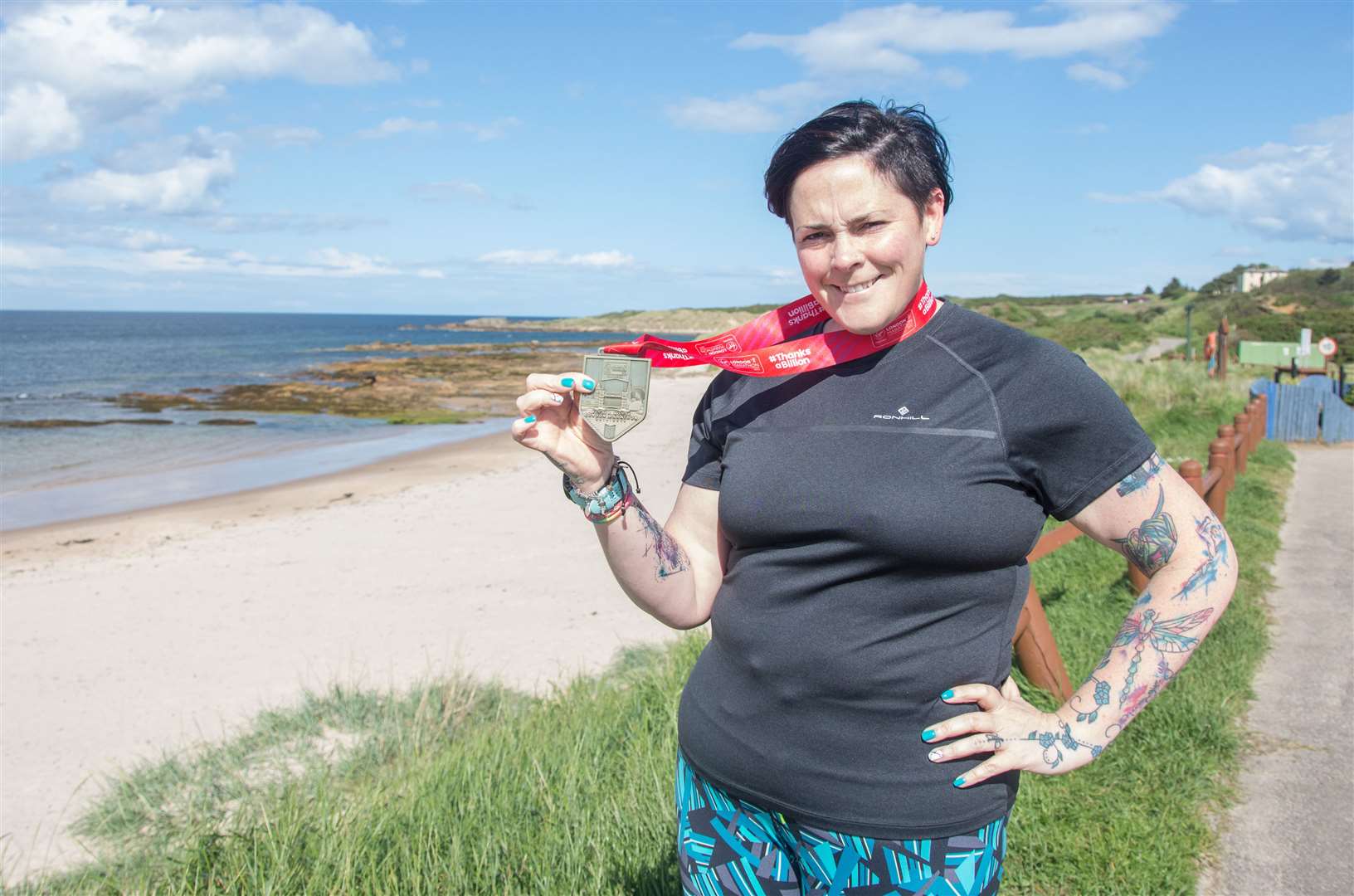 Jeni Johnston, a coach for Weight Watchers, has lost five stone. She's pictured with the medal she won for running the London Marathon in April. Picture: Becky Saunderson. Image No.044247.