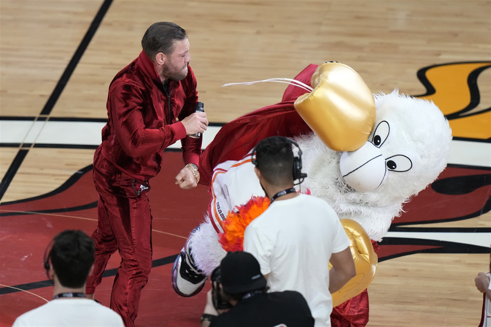 Former MMA fighter Conor McGregor punches Burnie, the Miami Heat mascot, during a break in Game 4 of the NBA Finals against the Denver Nuggets (Lynne Sladky/AP)