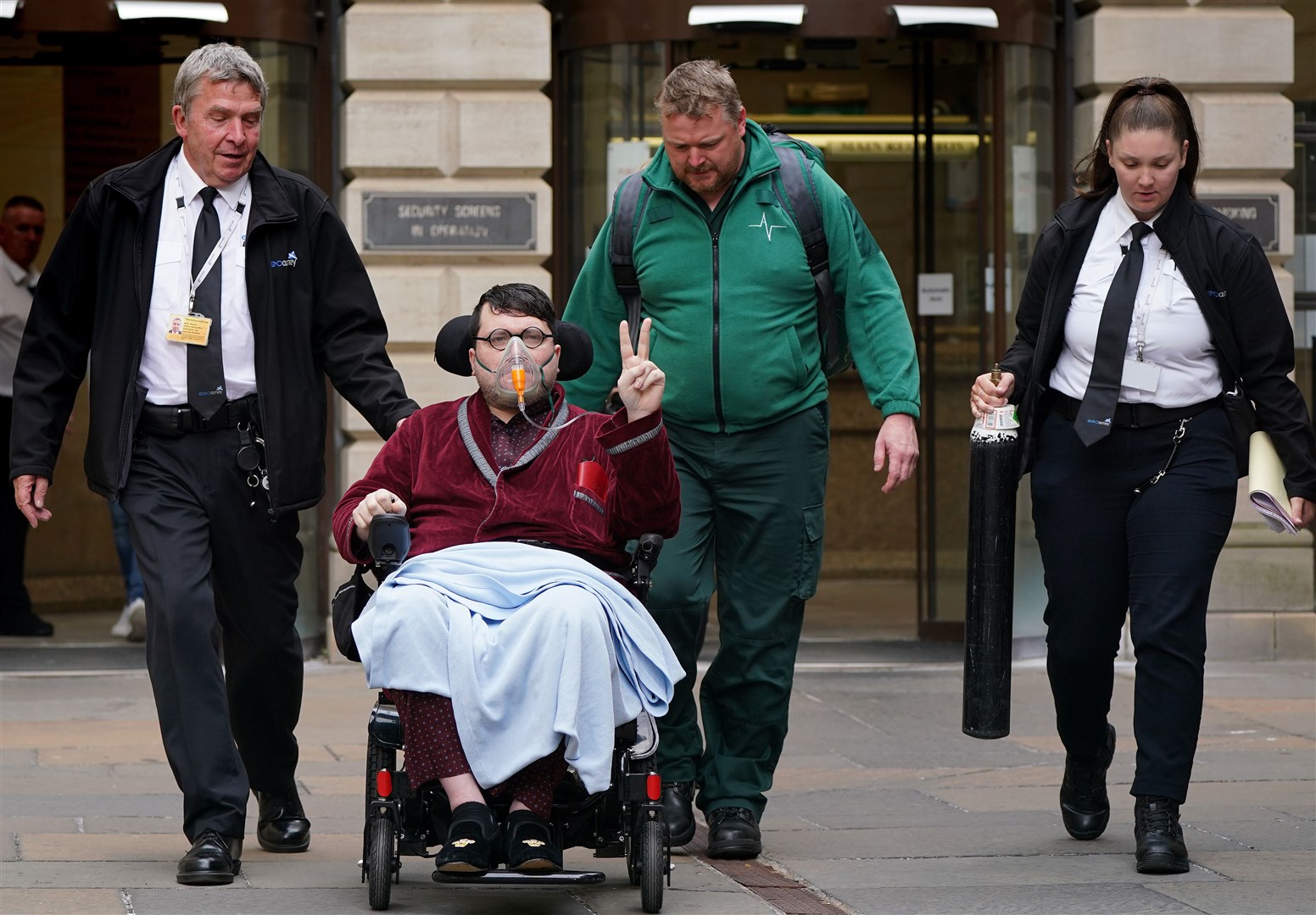 The suspect was accompanied by medics into the court (Andrew Milligan/PA)