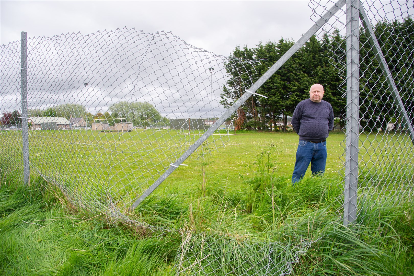 Forres Thistle Treasurer James Sutherland at the damaged area, although the club have made temporary repairs on some of the fence...The perimeter fence at Logie Park, home of Forres Thistle, has been vandalised...Picture: Daniel Forsyth..