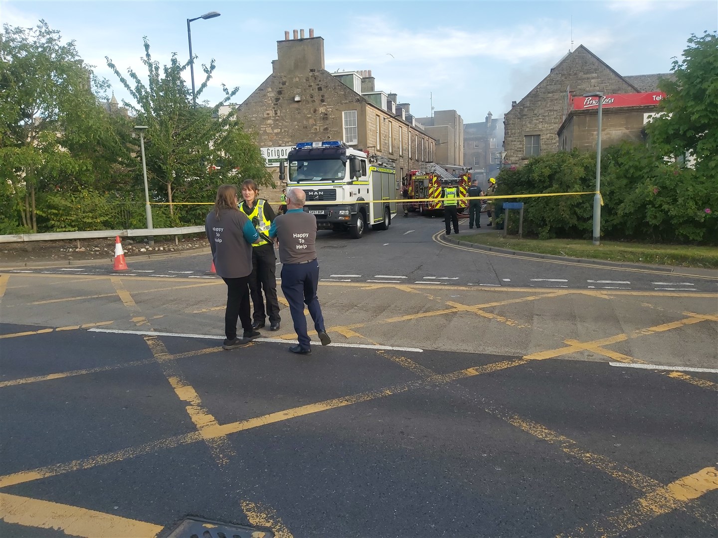 Poundland staff talk to a police officer at the scene. Picture: Highland News and Media