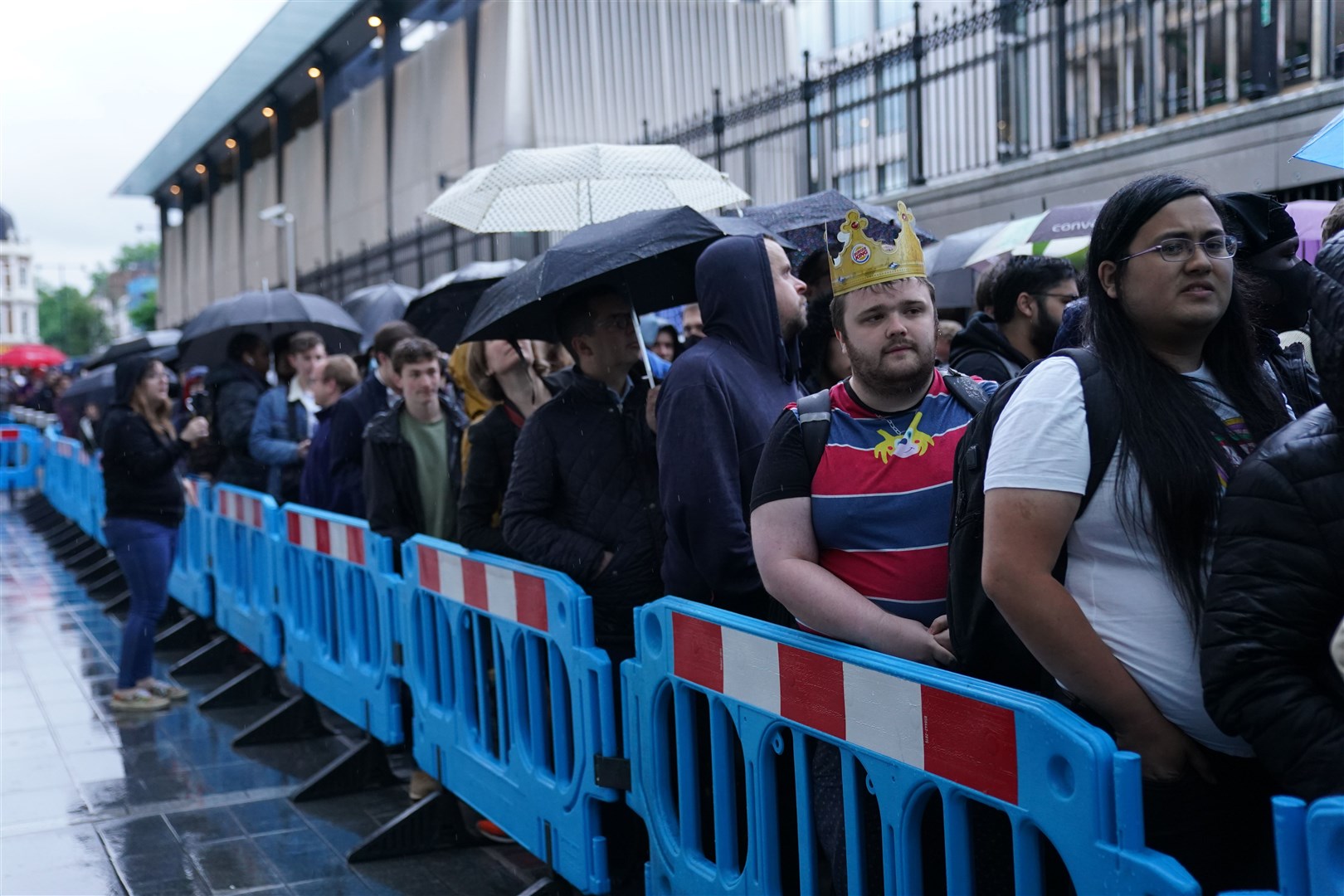 Crowds wait in line to board the first Elizabeth line train to carry passengers at Paddington Station, London (Kirsty O’Connor/PA)