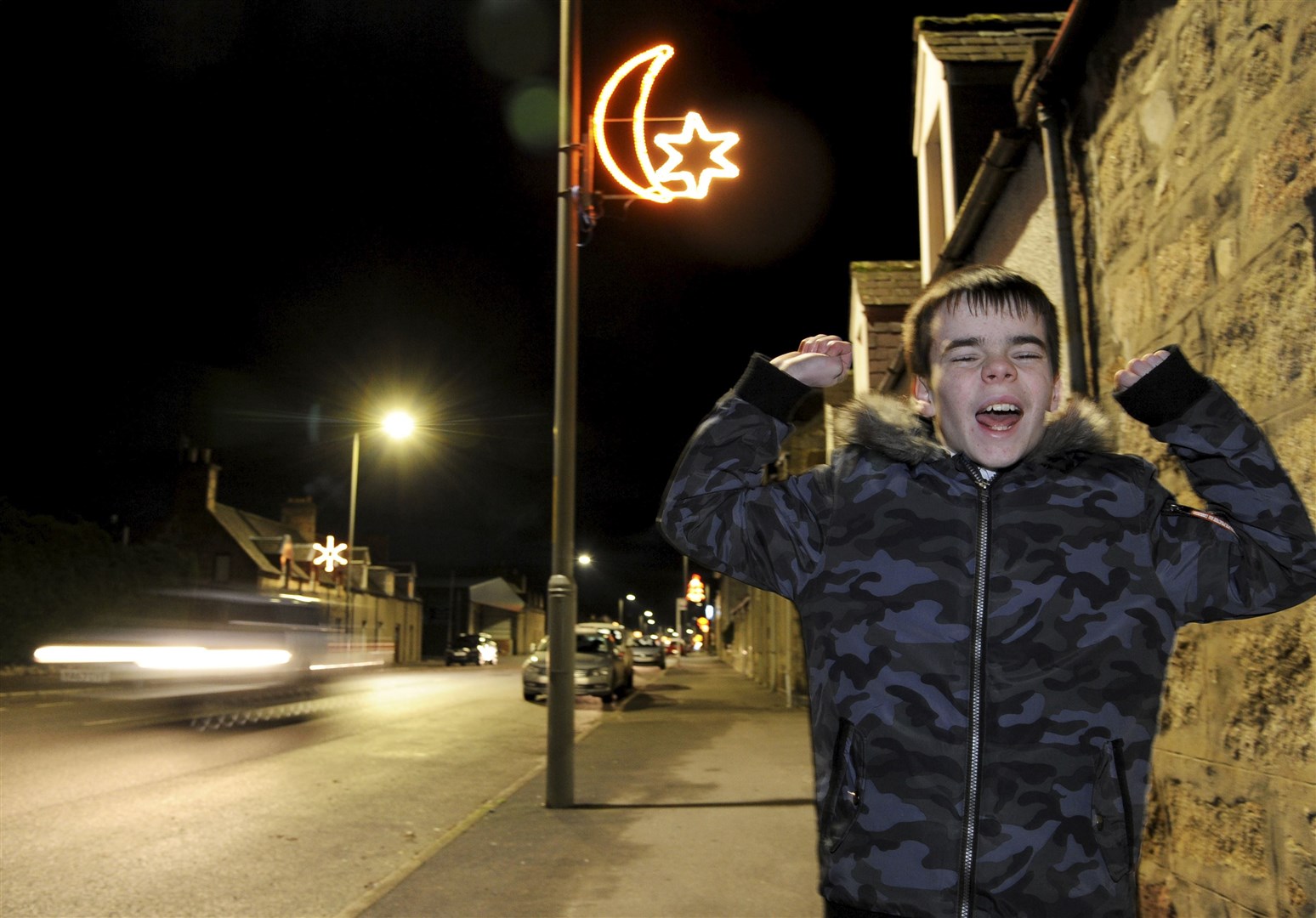 Aberlour schoolboy Ethan Butchart celebrates seeing his festive light illuminated for the first time. Picture: Eric Cormack.