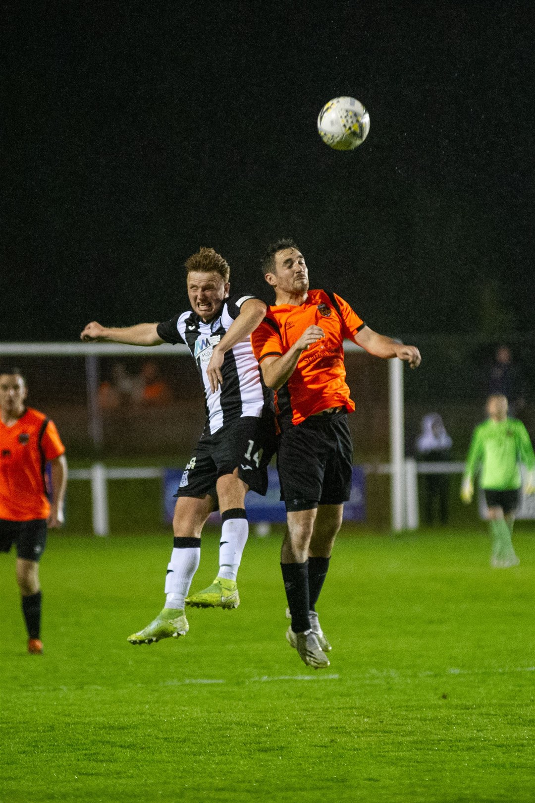 Elgin City's Tony Dingwall goes against Rothes full back Ali Stark to win a high ball. Picture: Daniel Forsyth....
