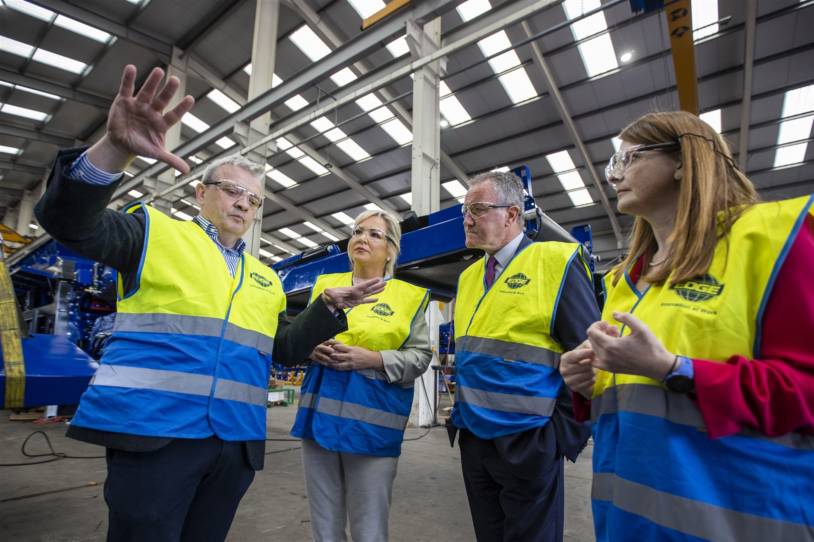 Darragh Cullen (left) shows Sinn Fein vice president Michelle O’Neill (second left) around the factory floor of his plant (Liam McBurney/PA)