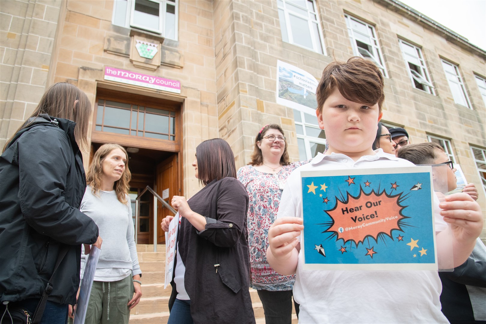 Demonstrators gather outside Moray Council's Headquarters ahead of a full council meeting to protest the proposed cuts to school staff. ..Picture: Daniel Forsyth..