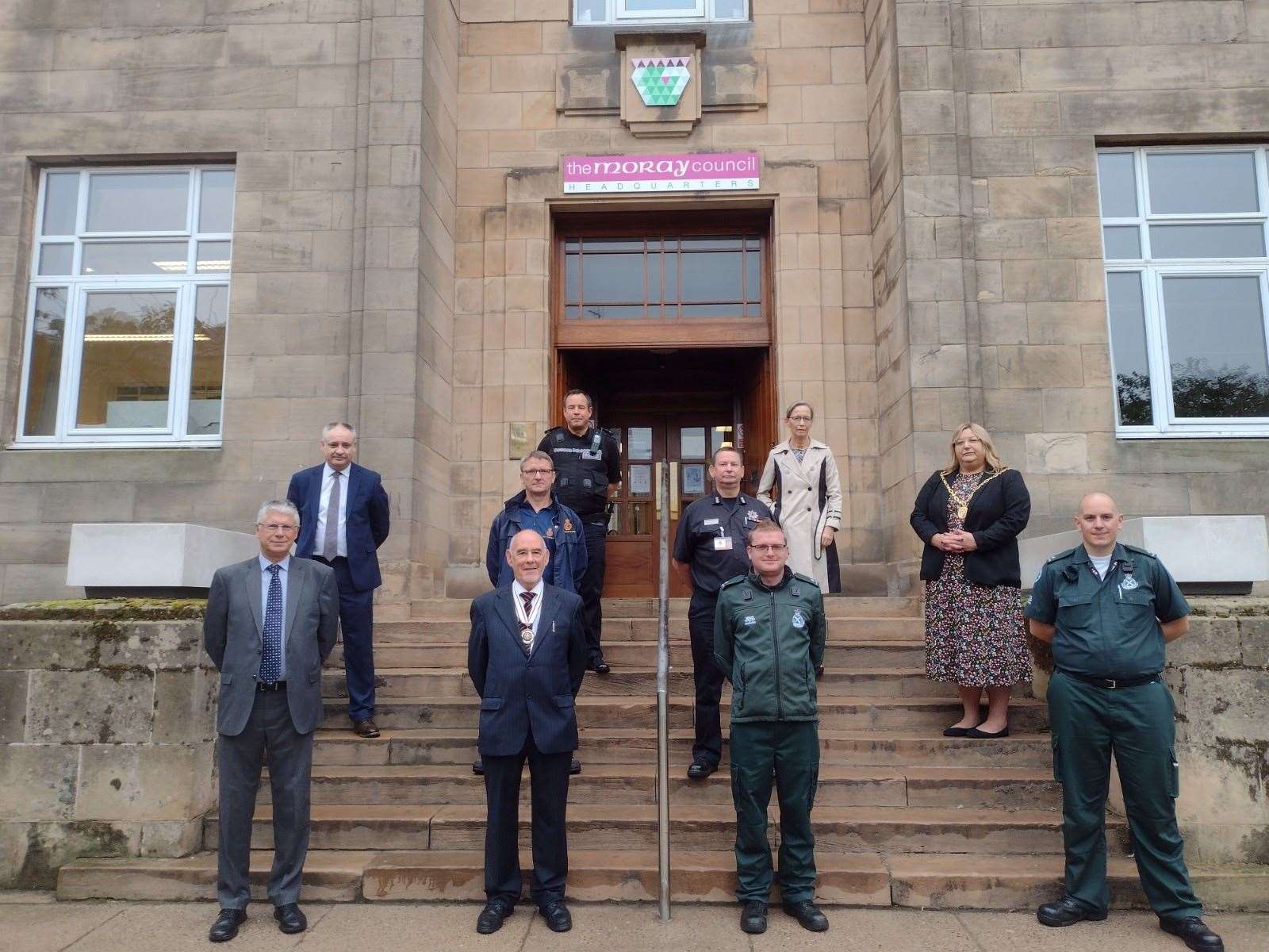 Moray Council leaders and community and emergency services representatives gather to observe Emergency Services Day at council headquarters in Elgin.
