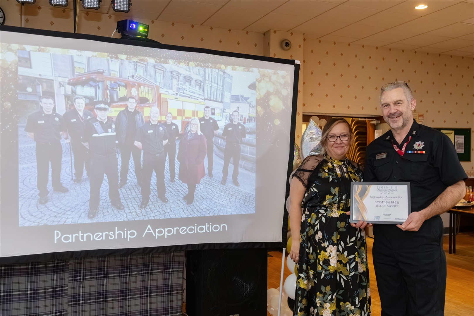 Angela Norrie, Elgin BID's manager, presented a special partnership appreciation award to Andy Illston on behalf of the Scottish Fire & Rescue Service. Picture: Beth Taylor.
