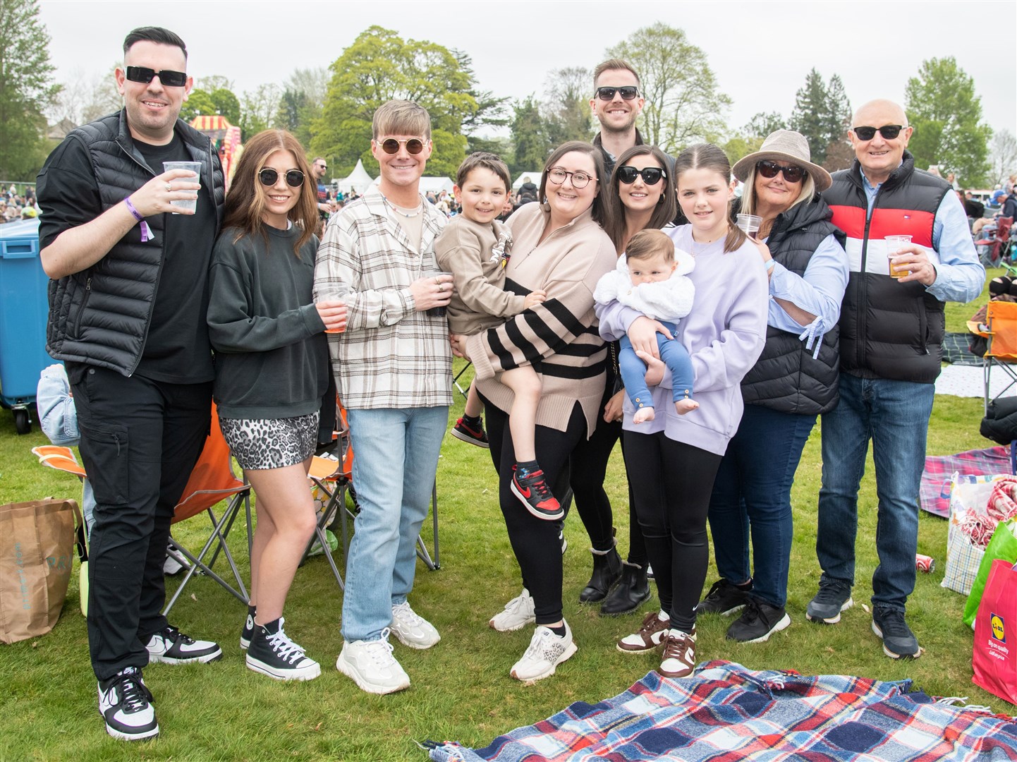 Eilidh Richardson (centre) with friends and family during the Saturday of the festival. MacMoray Music Festival 2024, held at Cooper Park, Elgin. Picture: Daniel Forsyth.