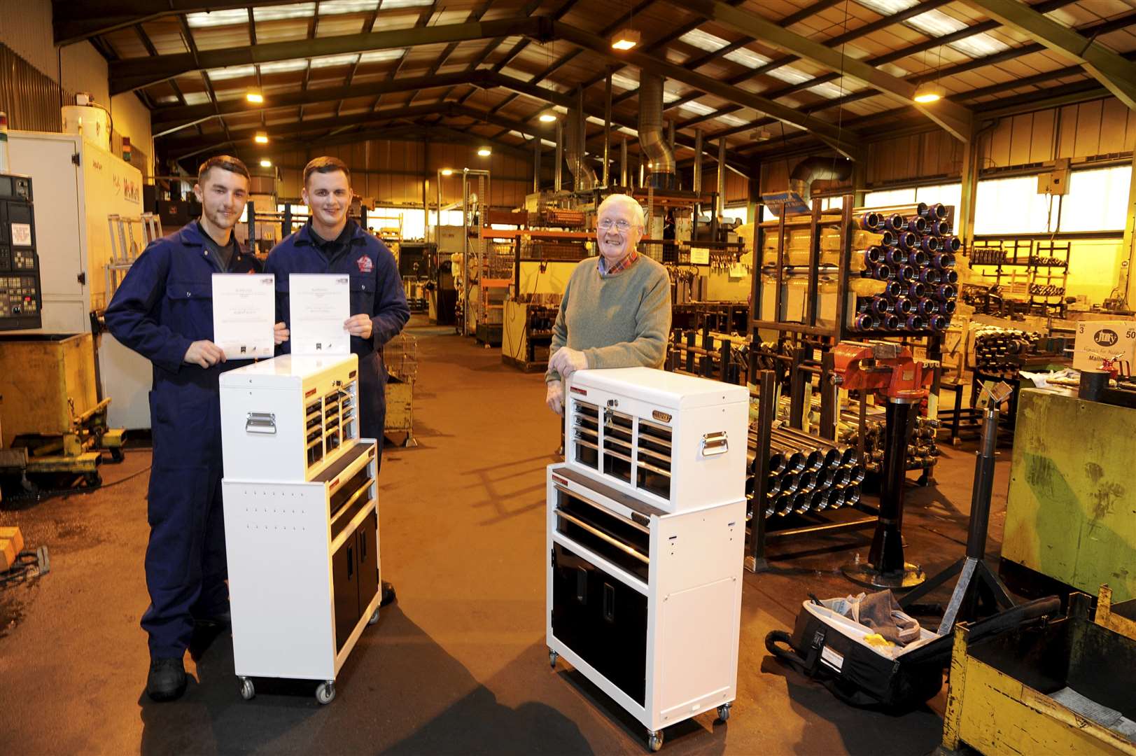 Robert Scott (left) and Scott Coull completed their apprenticeships with Hendry Hydraulics in Elgin. Mr Mike Hendry Snr (far right) handed over their certificates from Inverness College.