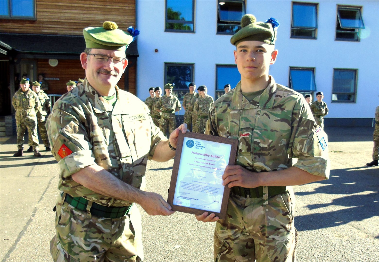Cdt Duncan Brown (right) being presented with his ACCT Praiseworthy First Aid Certificate by the Battalion's Commandant Col Mike MacDonald.