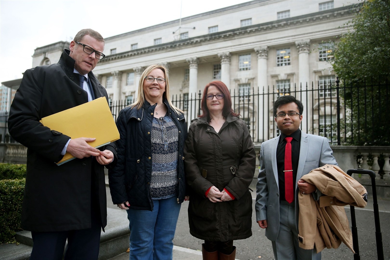 Dalton family members Phyllis Kealey (second right) and her sister Rosaleen Quigley stand outside the High Court in Belfast with their solicitor Kevin Winters (left) and legal executive Anurag Deb (PA)