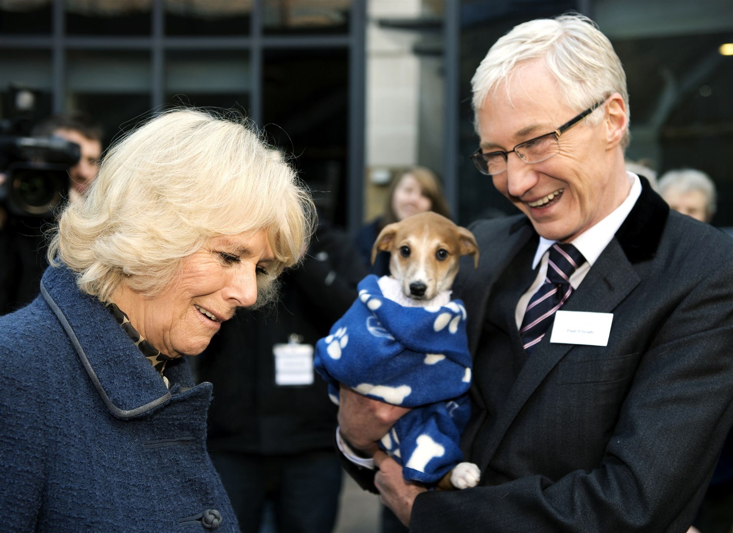 Paul O’Grady with the Queen Consort, then the Duchess of Cornwall, during a visit to Battersea Dogs and Cats Home in London in 2012 (Adrian Dennnis/PA)