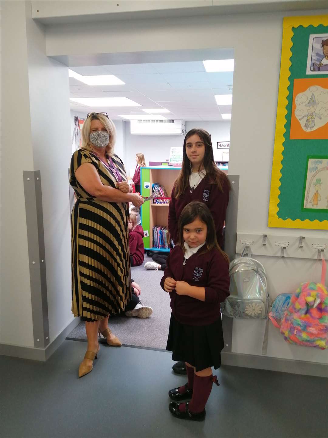 Chief education officer Vivienne Cross is joined by pupils Zuri Andrew and Lucie Scott in declaring the library open.