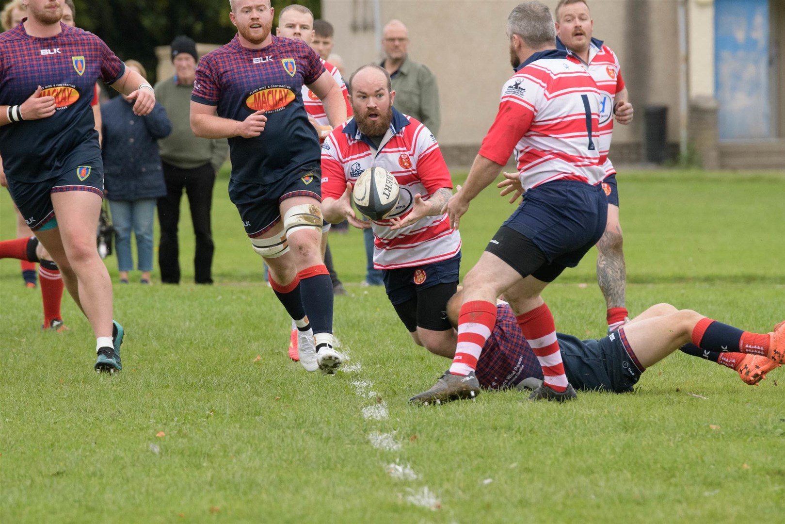 Ian Thomson offloads to Chris Robottom in tackle. Picture: Colin Little