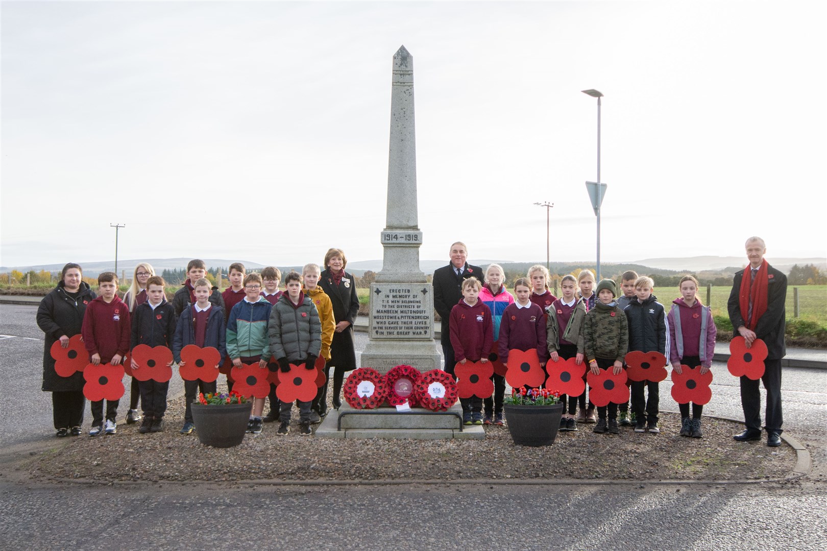 School pupils from Mosstowie Primary at the war memorial in Miltonduff. Picture: Daniel Forsyth