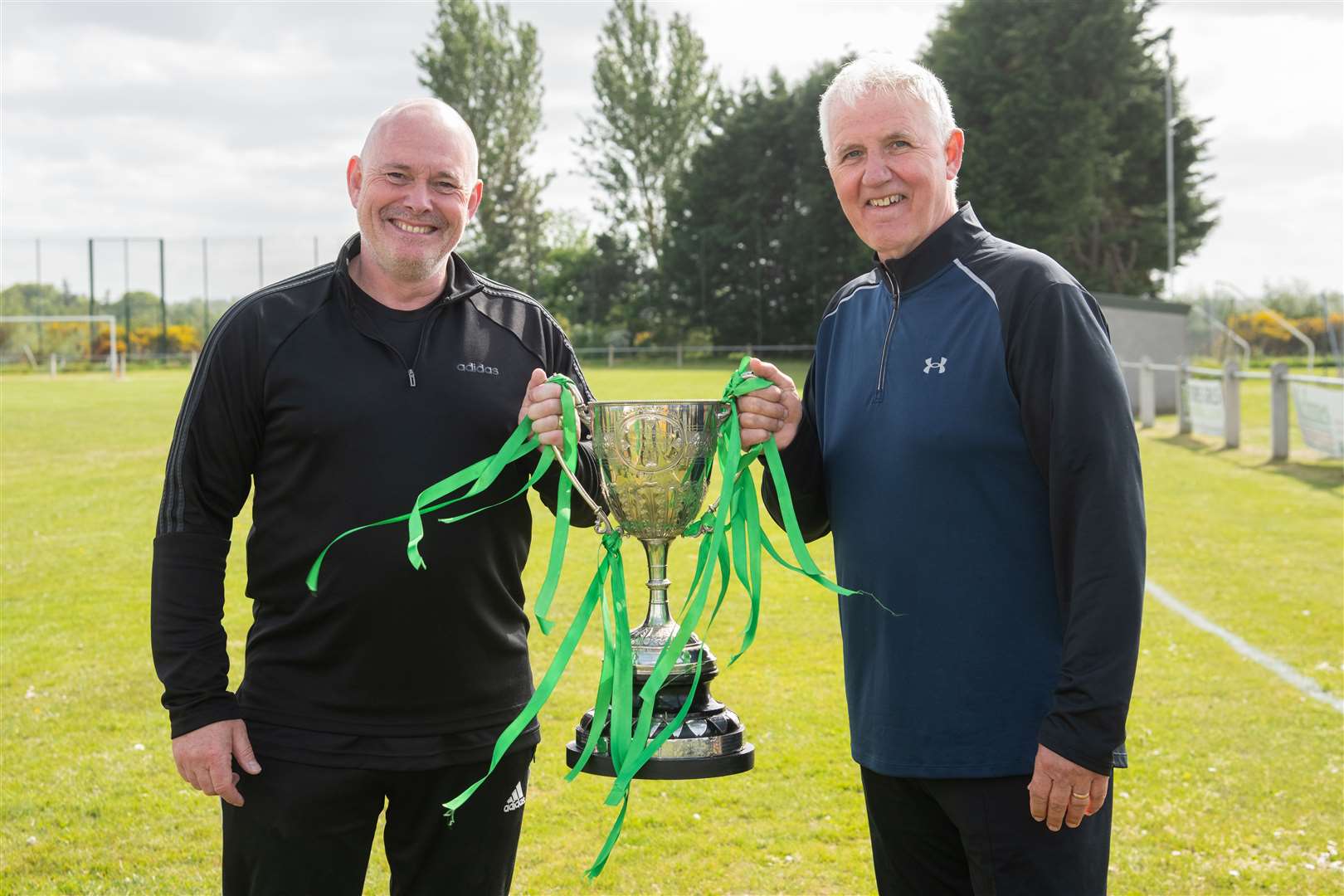 Charlie Charlesworth and Jim Stables with the trophy...Dufftown FC (2) vs Forres Thistle FC (2) - Dufftown FC win 5-3 on penalties - Elginshire Cup Final held at Logie Park, Forres 14/05/2022...Picture: Daniel Forsyth..