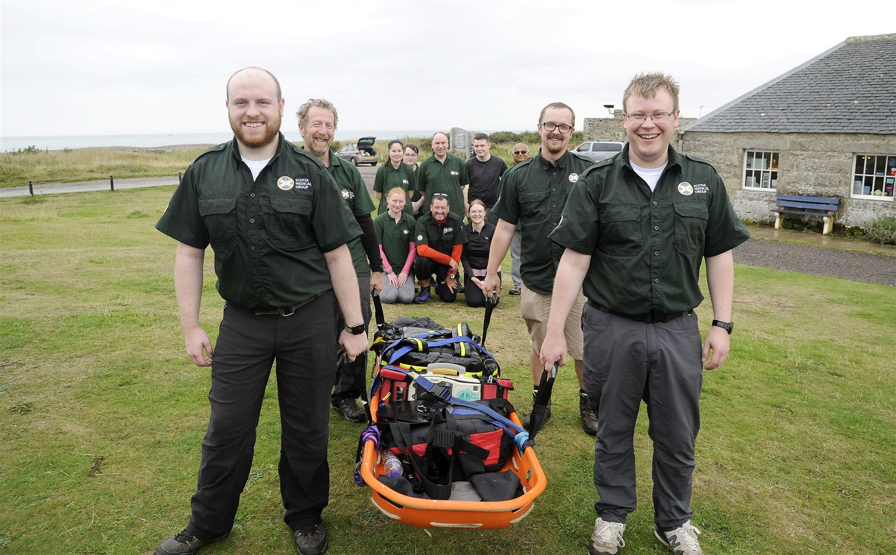 Volunteers from Scotia Medical Group at Spey Bay during their fundraising Speyside Way trek carrying a laden stretcher. Picture: Becky Saunderson.