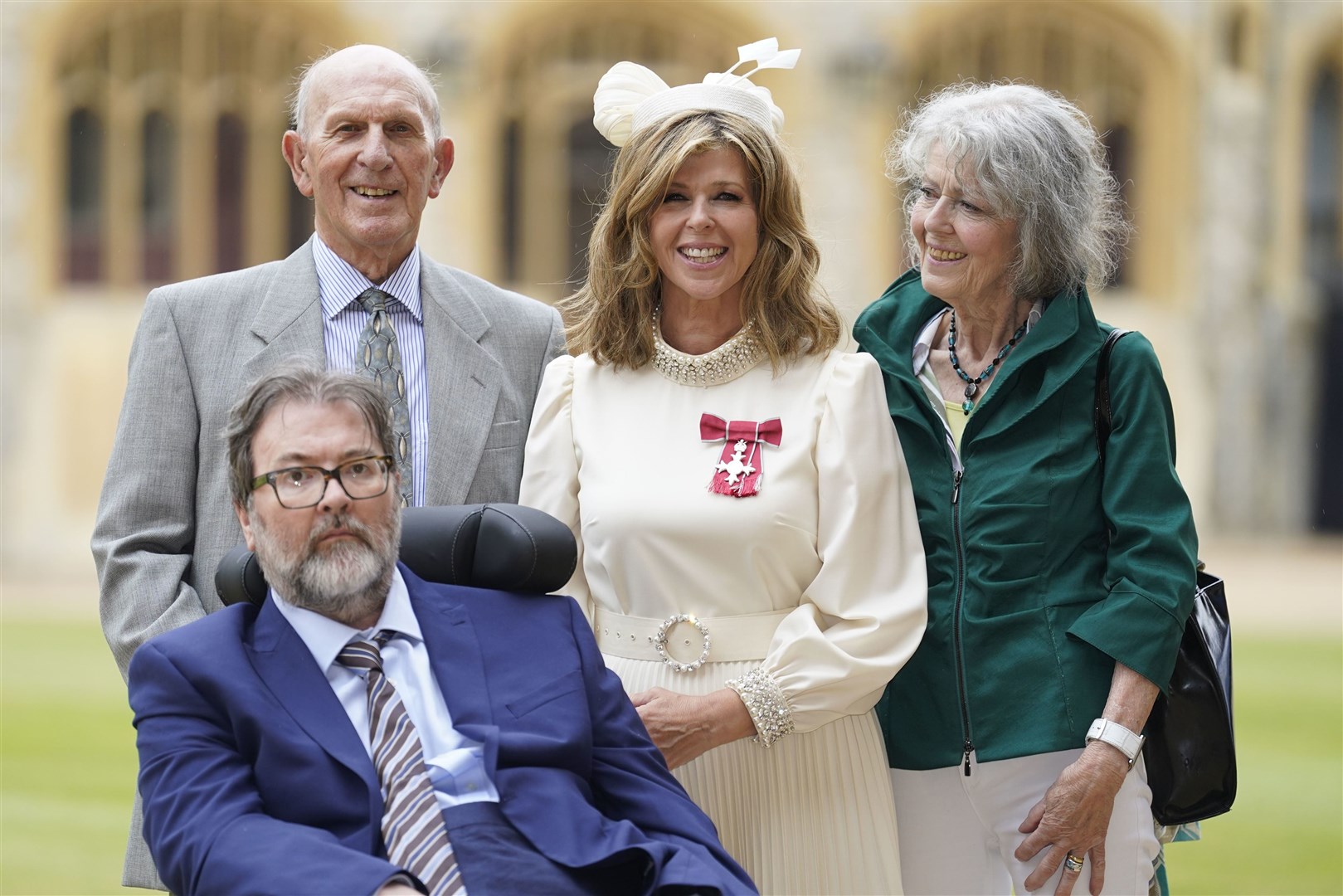 Kate Garraway, with husband Derek Draper and her parents, Gordon and Marilyn, after being made an MBE by the Prince of Wales (Andrew Matthews/PA)