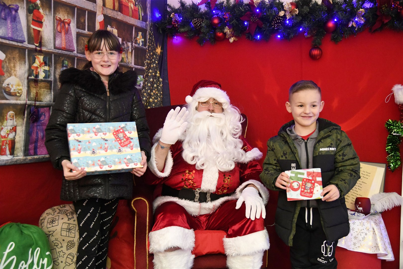 Santa with Isla (left) and Archie Laing (right) at his Grotto in the St Giles Centre in Elgin...Pictre: Beth Taylor.