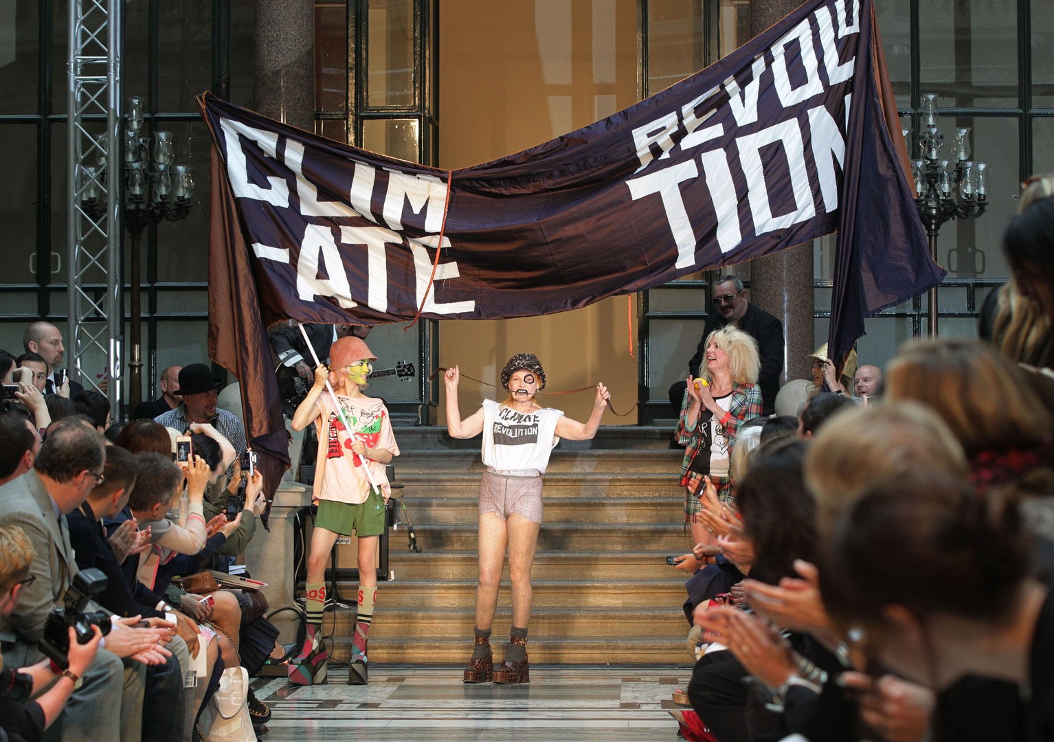 Westwood on the runway in 2012 in a T-shirt saying ‘climate revolution’ (Yui Mok/PA)
