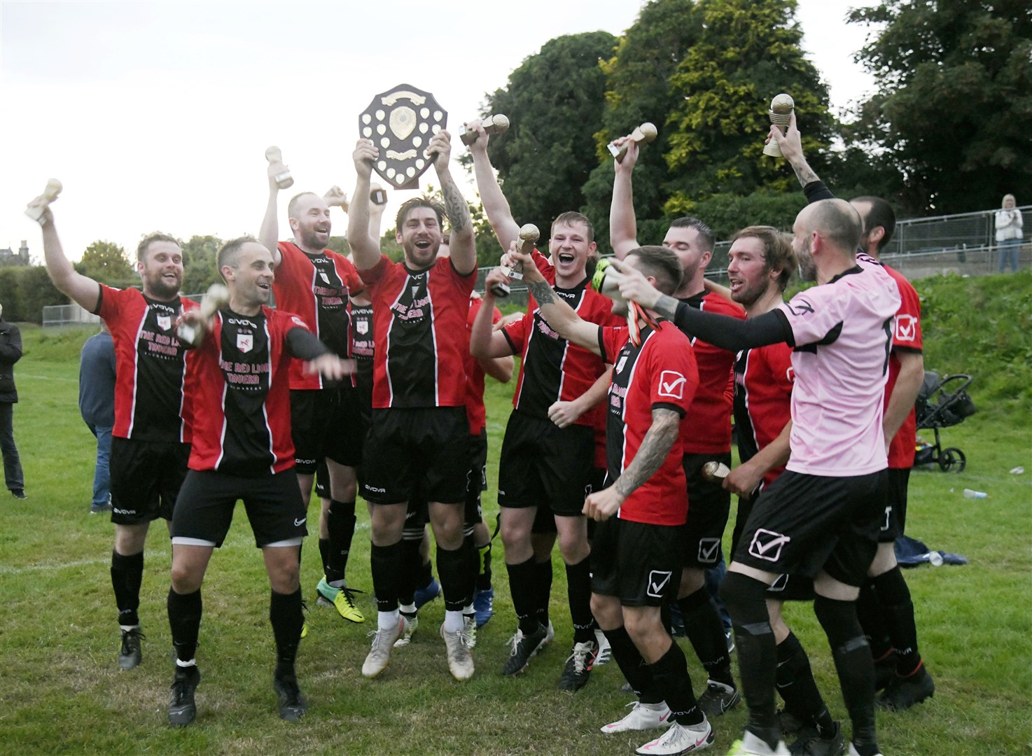 Let's get this party started as the Fochabers players celebrate with the trophy. Picture: Beth Taylor
